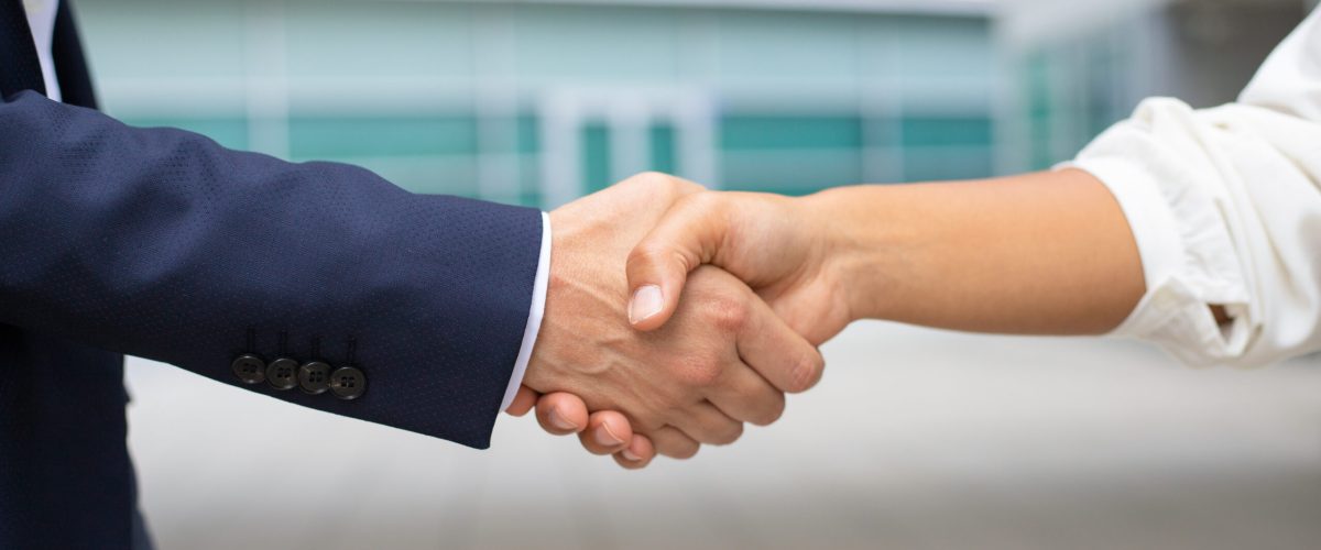 Closeup shot of business handshake. Cropped shot of two people wearing formal suits shaking hands. Business handshake concept